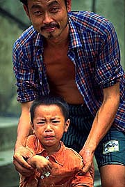 crying-boy-with-father