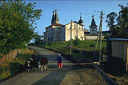 Peasant with cow with Ferapontovo at the background
