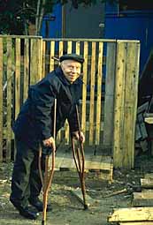 Man on crutches in Kem